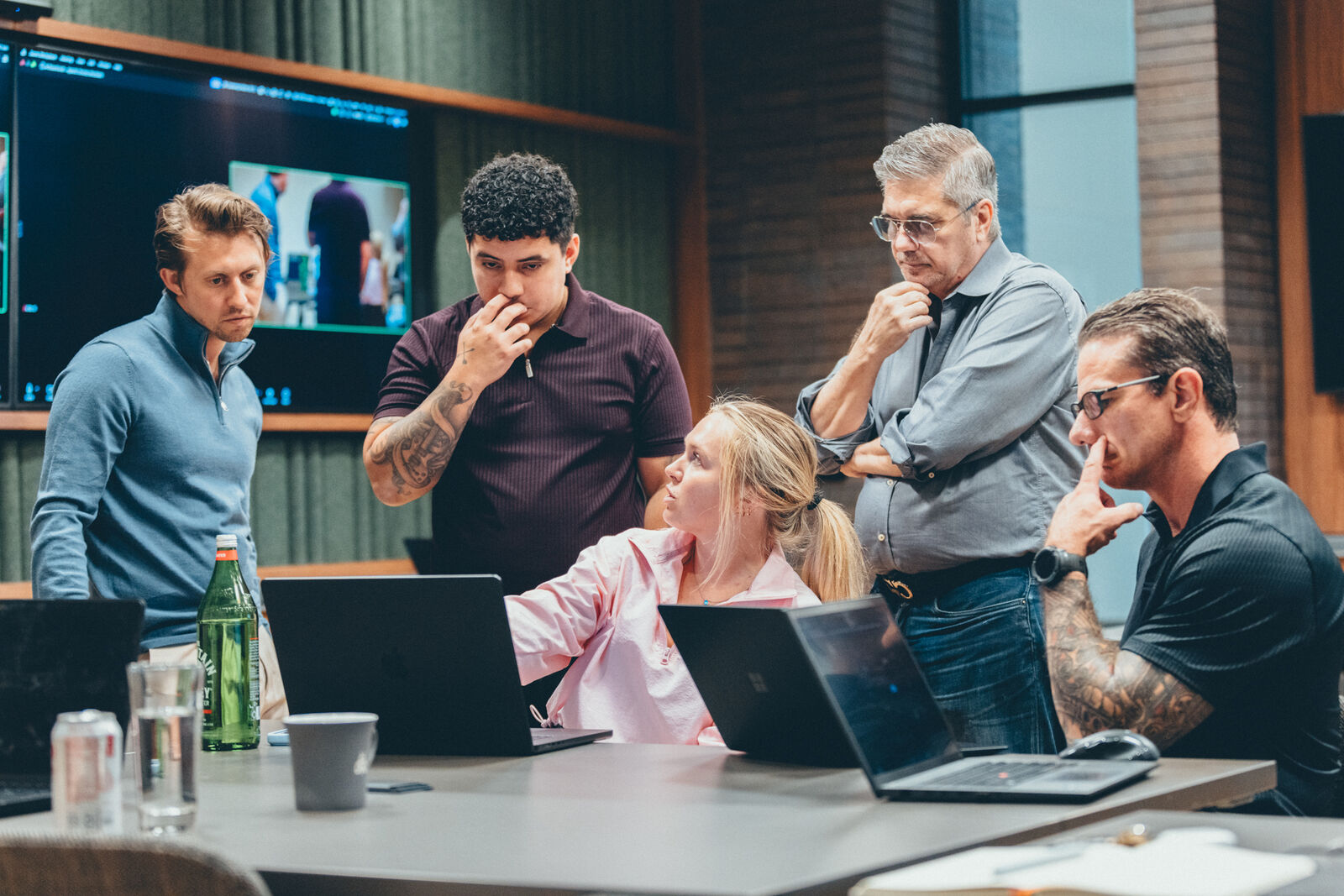 Oscar Hidalgo working through a problem with a team of business owners around a conference table